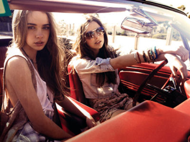 2 young ladies in a red car